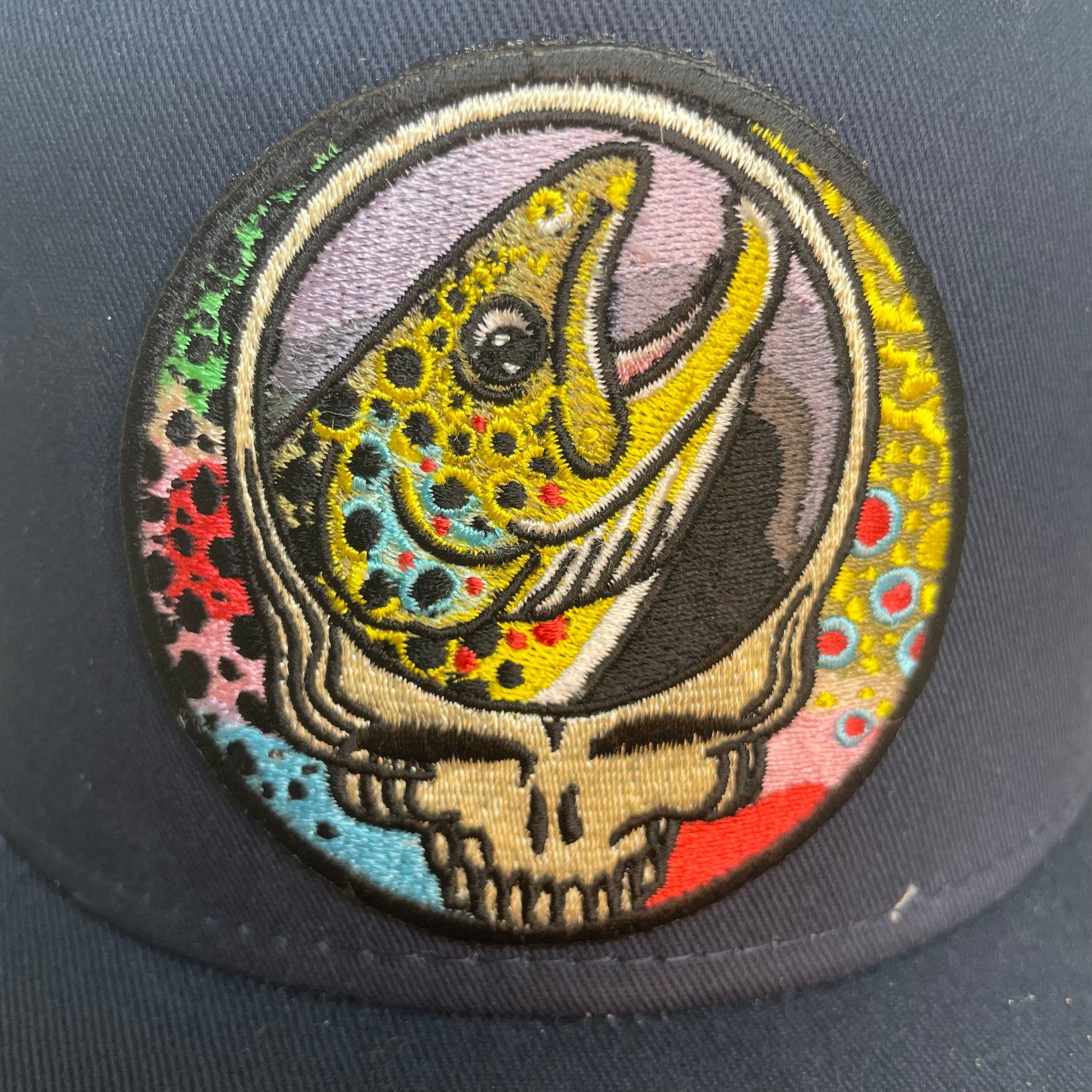 Steal Your Face Brown Trout Trio Classic Trucker Hat Gunmetal Gray River Patch Closeup Fishing Hat